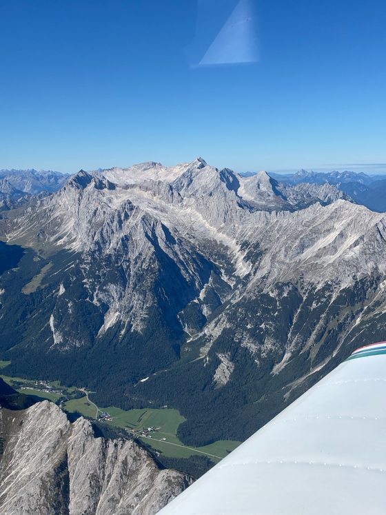 Rugged peaks of the Wetterstein range seen from the aircraft, with the Piper's wing